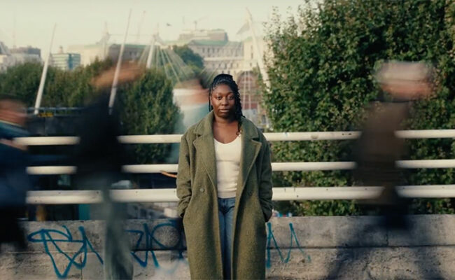 Le'Seye facing the camera against city backdrop